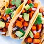 Three sweet potato and black bean tacos on a plate