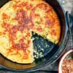 Cornbread in a Dutch oven with a slice taken out