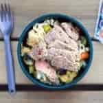 Stir fry noodles and beef in a green camping bowl